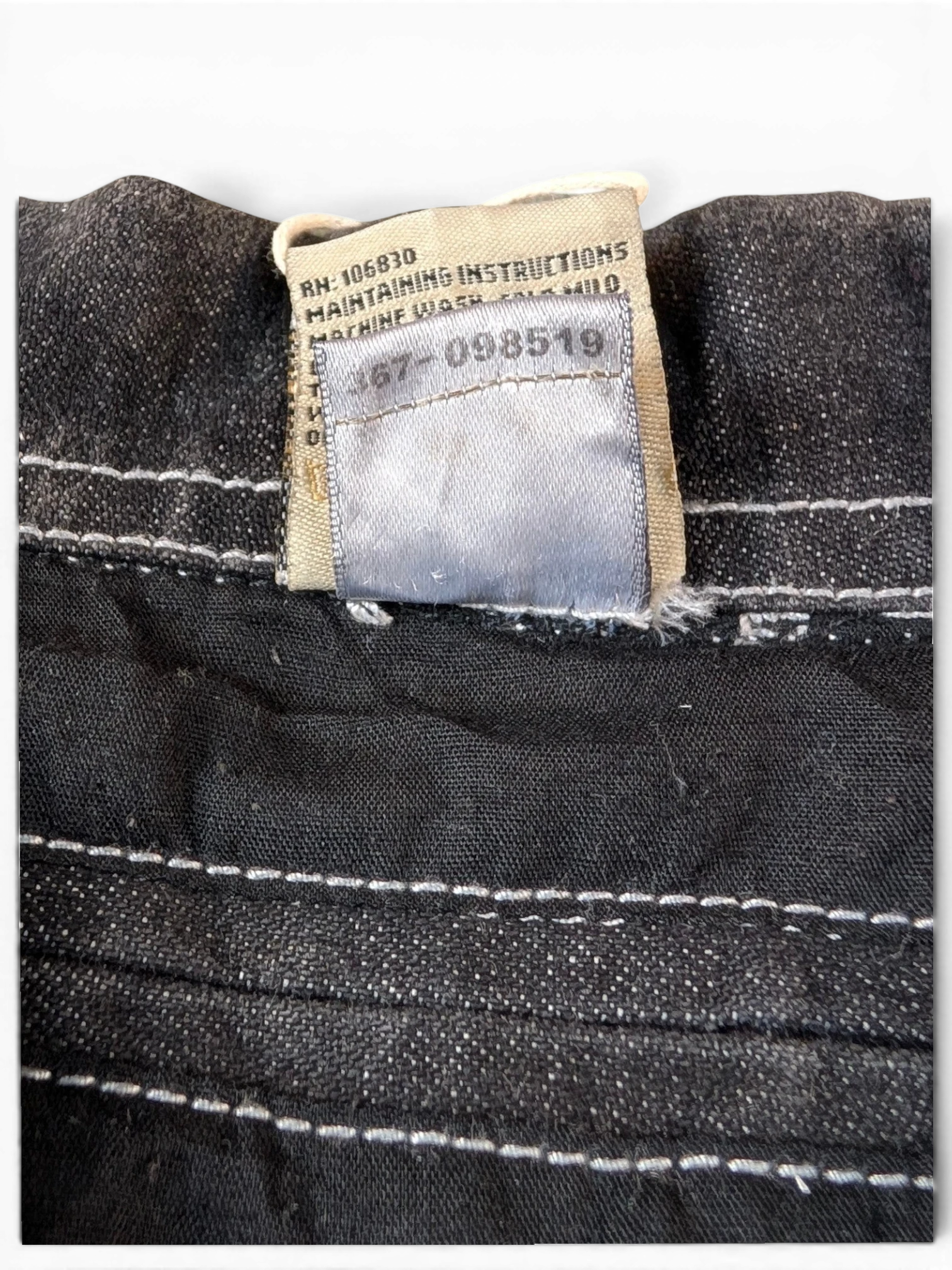 JAKE & IPI State Property dark wash denim jacket with white contrast stitching and care label.