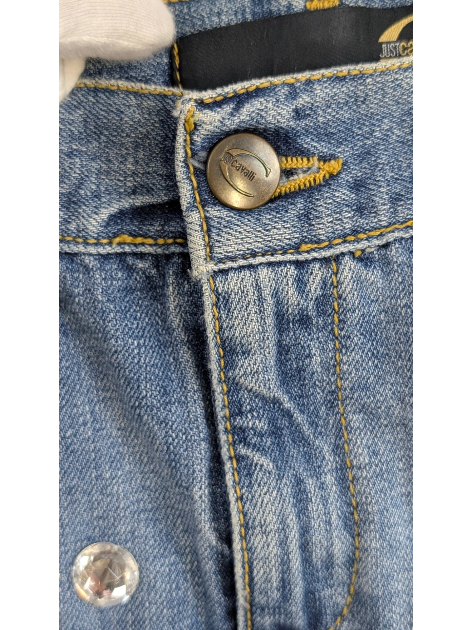 JAKE & IPI blue denim mini skirt with rhinestone embellishment and branded button, early 2000s Y2K style.
