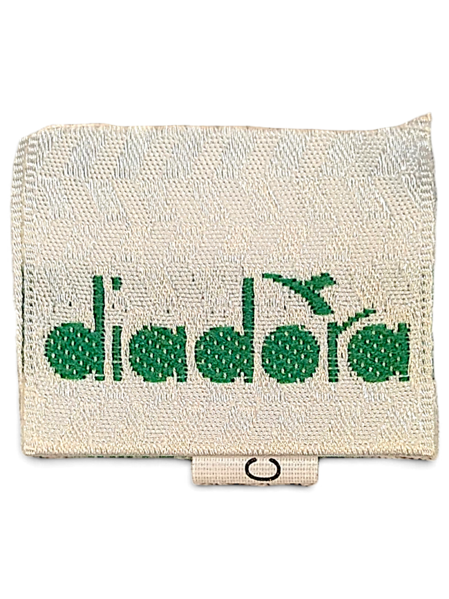 JAKE & IPI Diadora brand clothing label with green embroidered logo on a cream fabric tag