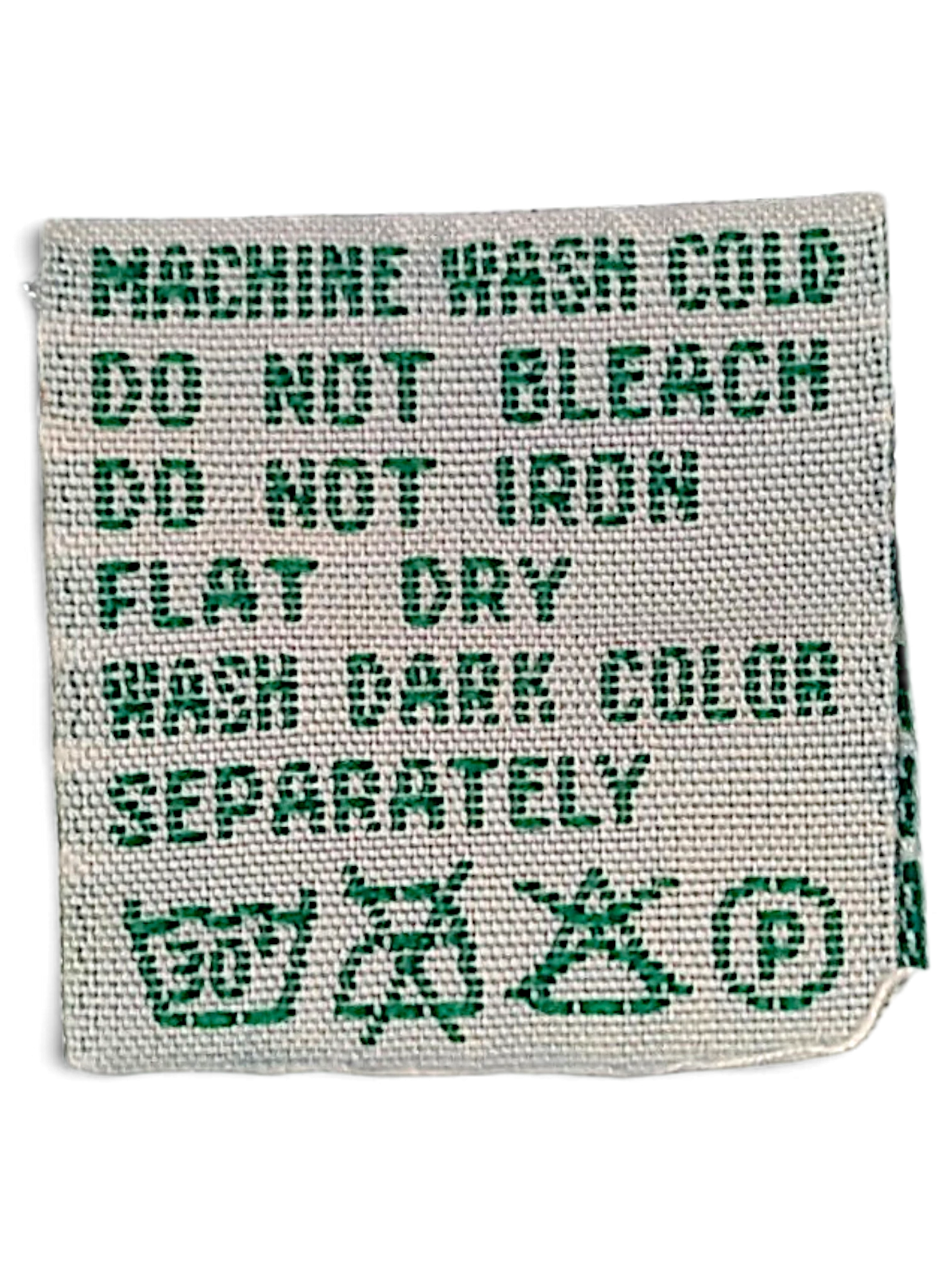 JAKE & IPI Diadora track pants care label with green text on white fabric showing washing instructions