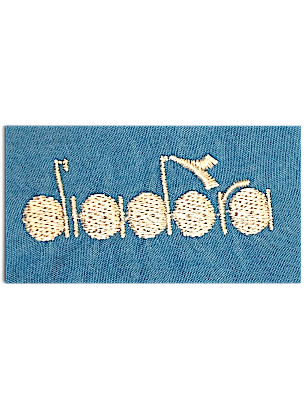 JAKE & IPI Diadora light blue track pants featuring a detailed white embroidered logo on faded fabric