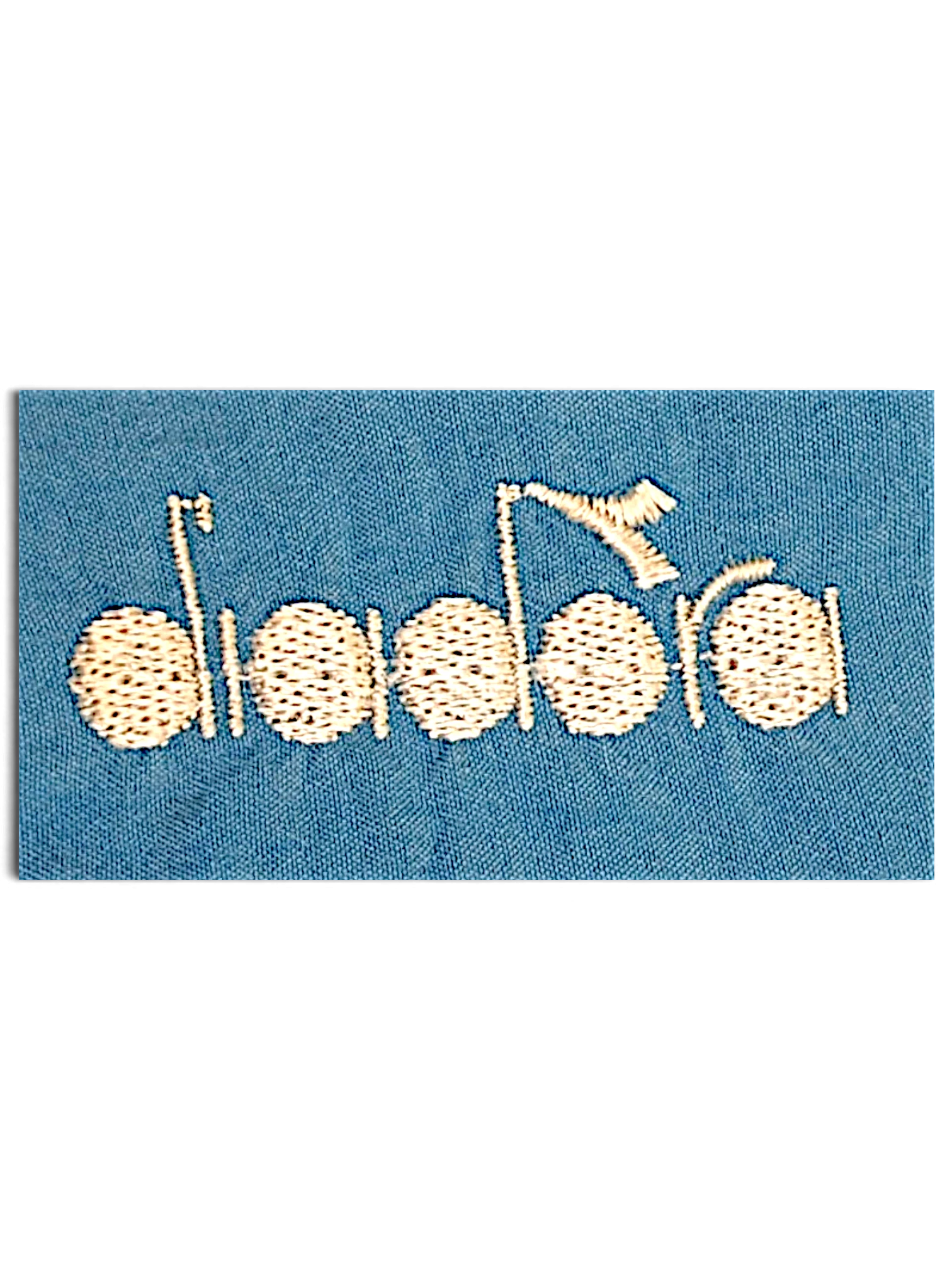 JAKE & IPI Diadora light blue track pants featuring a detailed white embroidered logo on faded fabric