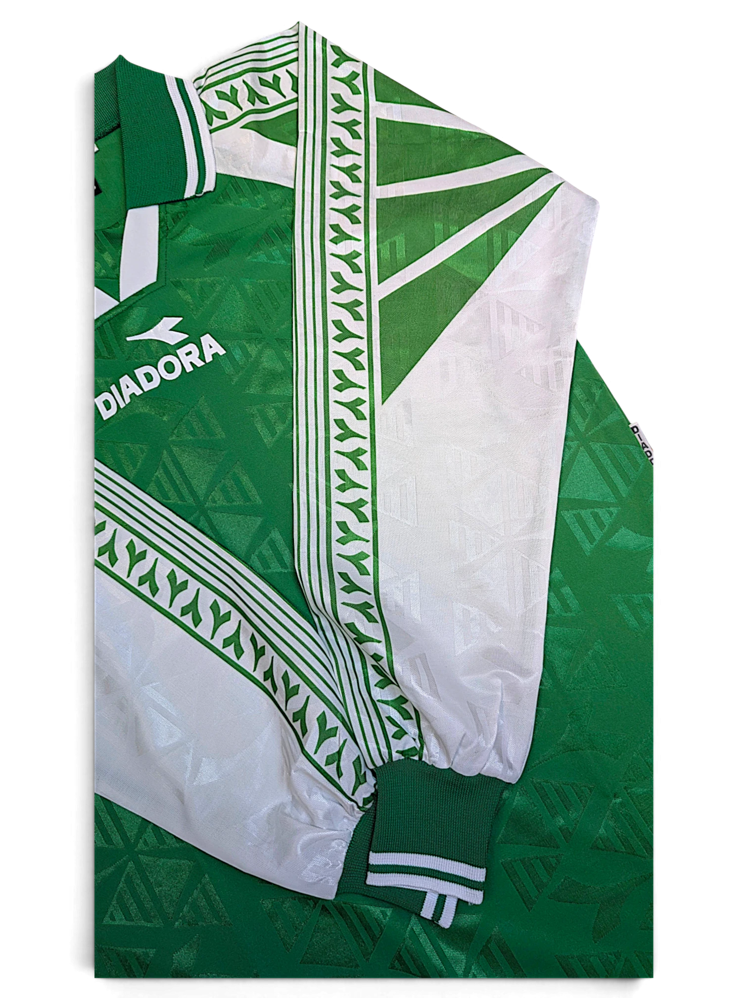 JAKE & IPI Diadora Grit green football jersey showing contrast white sleeve panels and logo taping