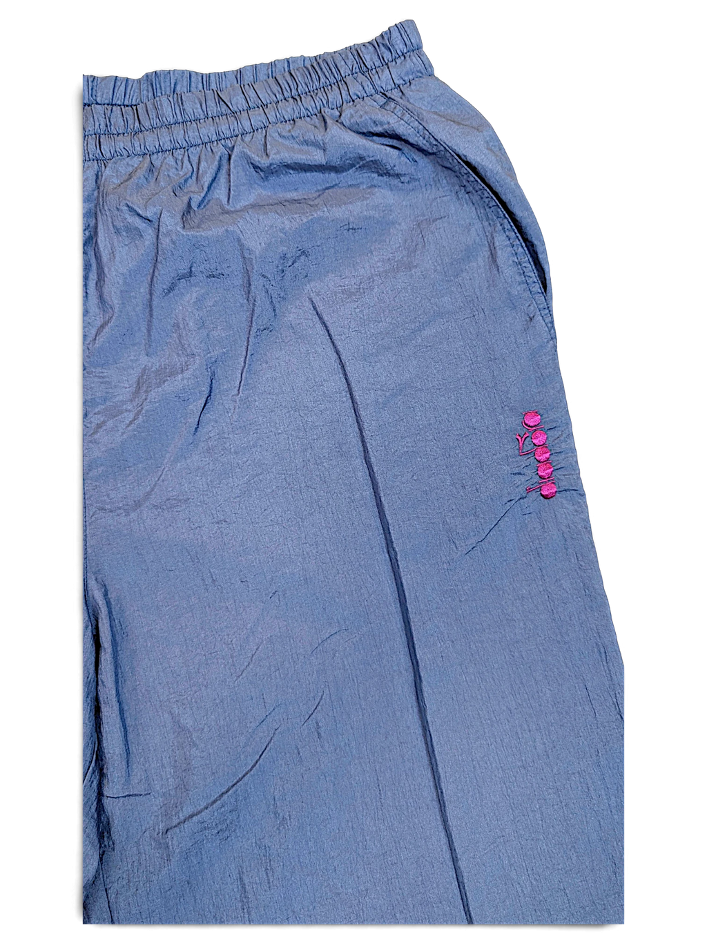 JAKE & IPI Diadora light blue shiny track pants with an elasticated waistband and pink embroidered logo detail.