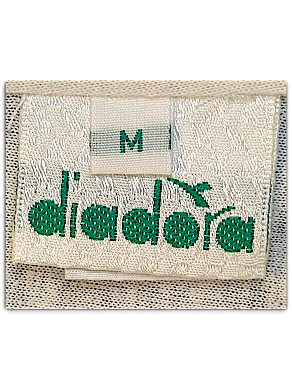 JAKE & IPI Diadora track pants size M clothing label with green embroidered logo on white fabric