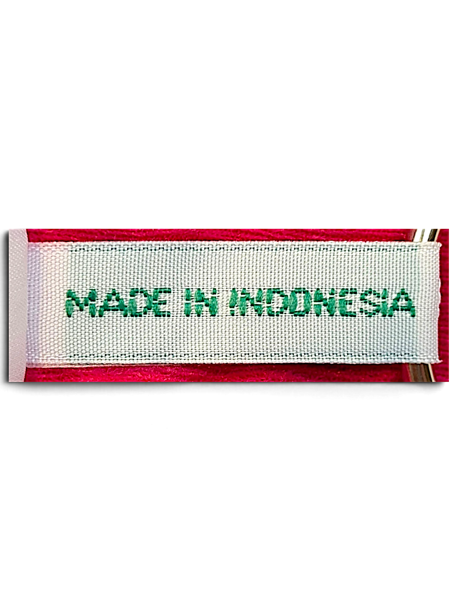 JAKE & IPI Diadora pink track pants garment tag showing Made in Indonesia text on a white fabric label