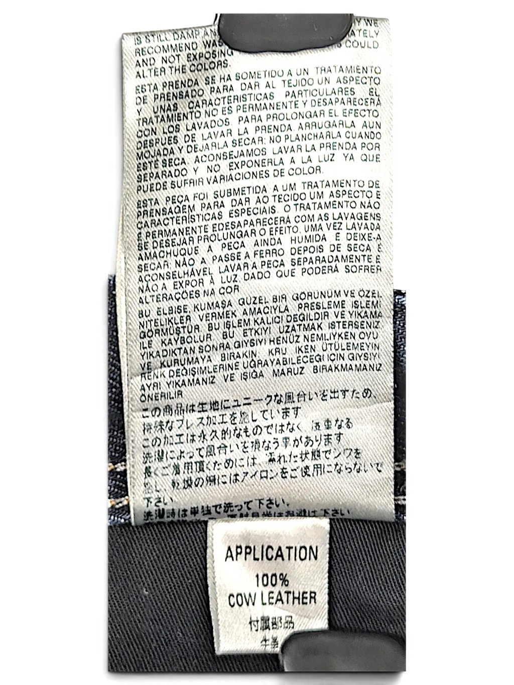 JAKE & IPI Diesel Krooley jeans interior care label and 100% cow leather application tag on dark blue denim