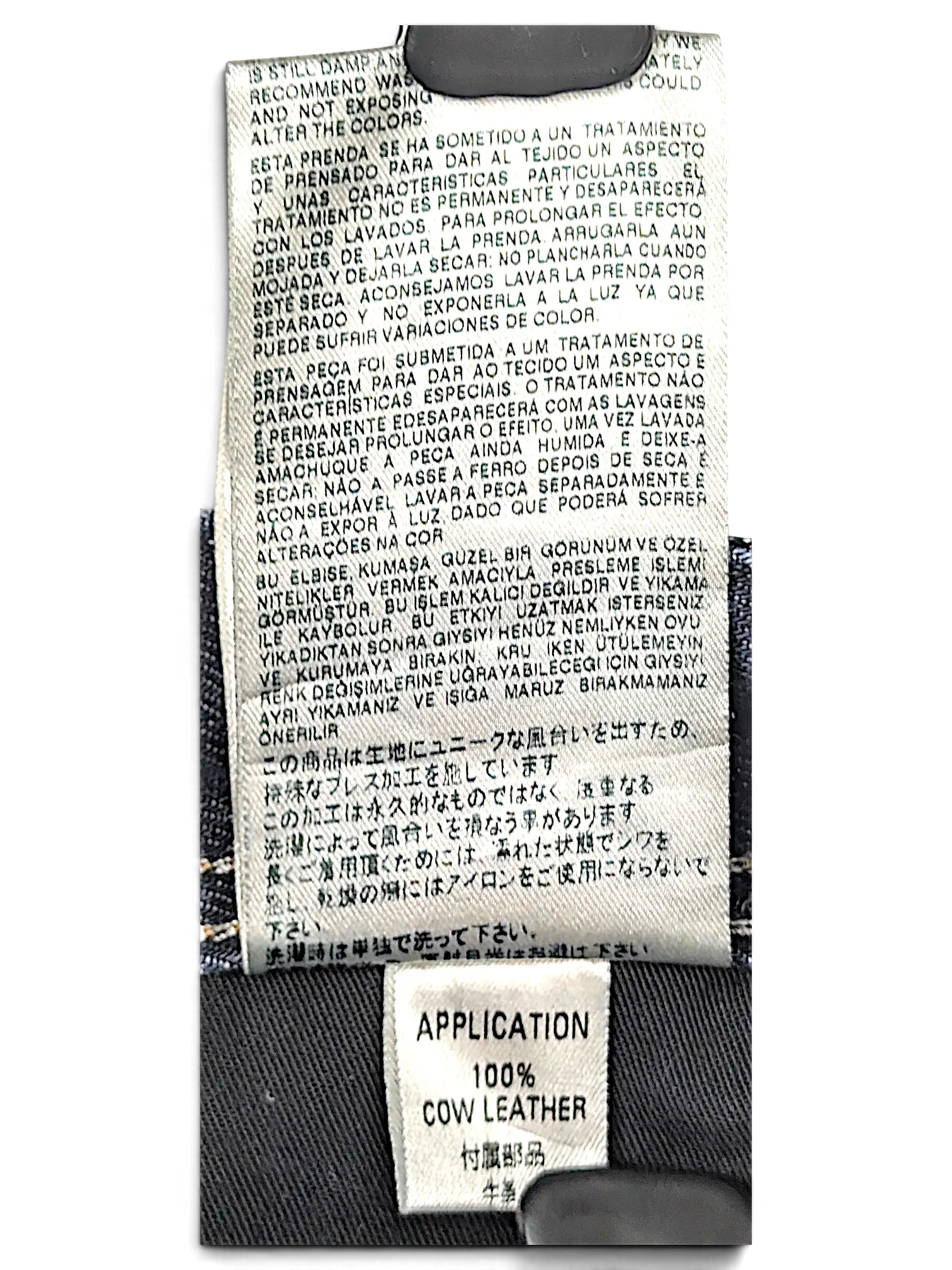 JAKE & IPI Diesel Krooley jeans interior care label and 100% cow leather application tag on dark blue denim