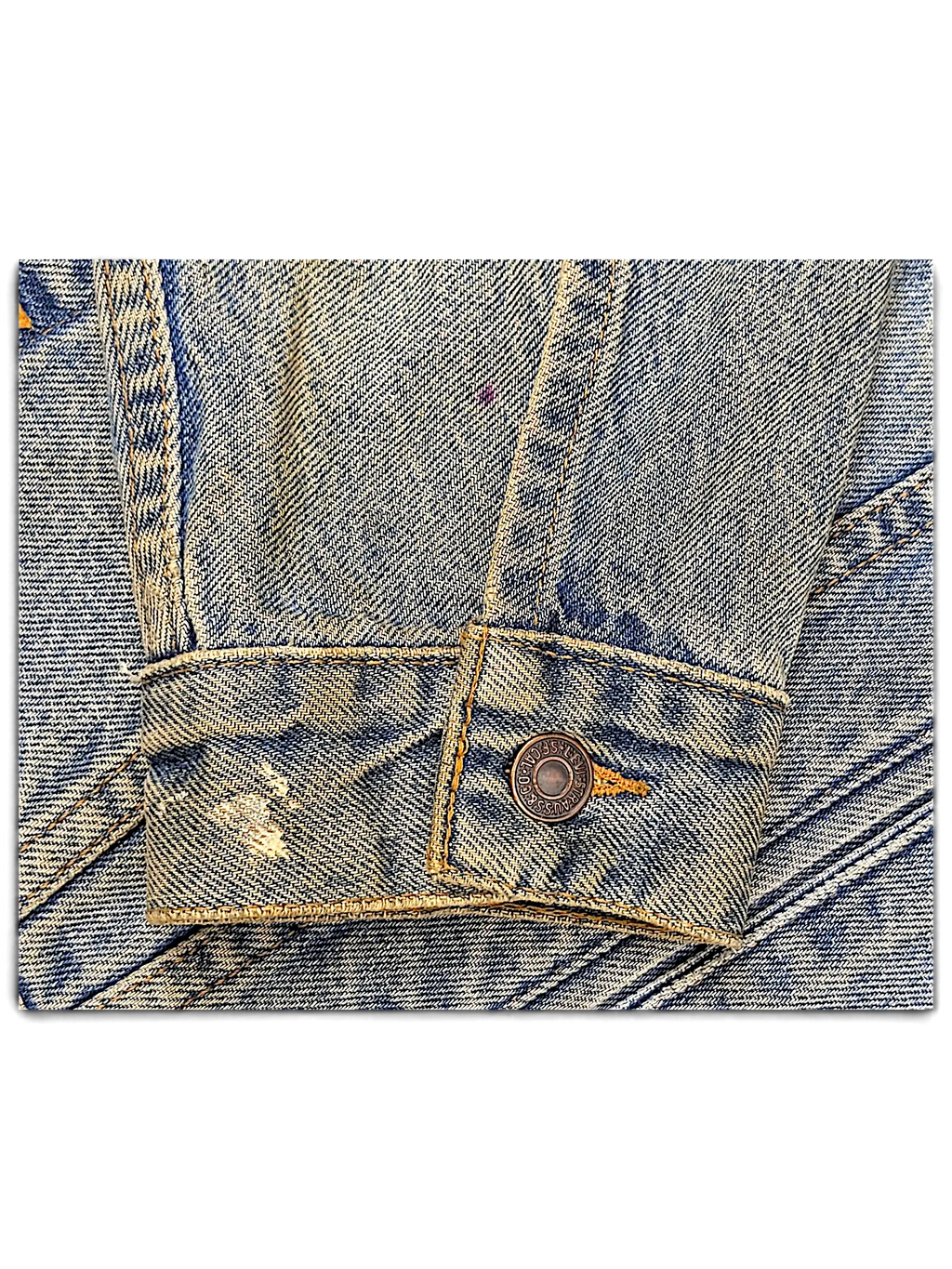 JAKE & IPI distressed blue denim jacket sleeve with metal button detail and vintage wash finish