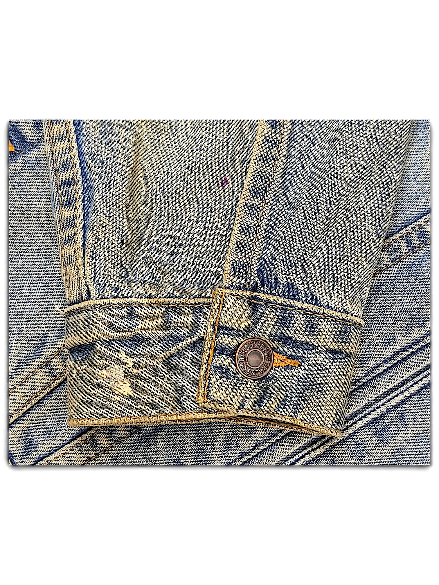 JAKE & IPI distressed blue denim jacket sleeve with metal button detail and vintage wash finish