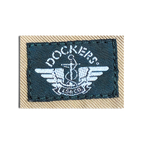 JAKE & IPI Dockers brand logo label embroidered in white on a dark green patch against beige cotton fabric