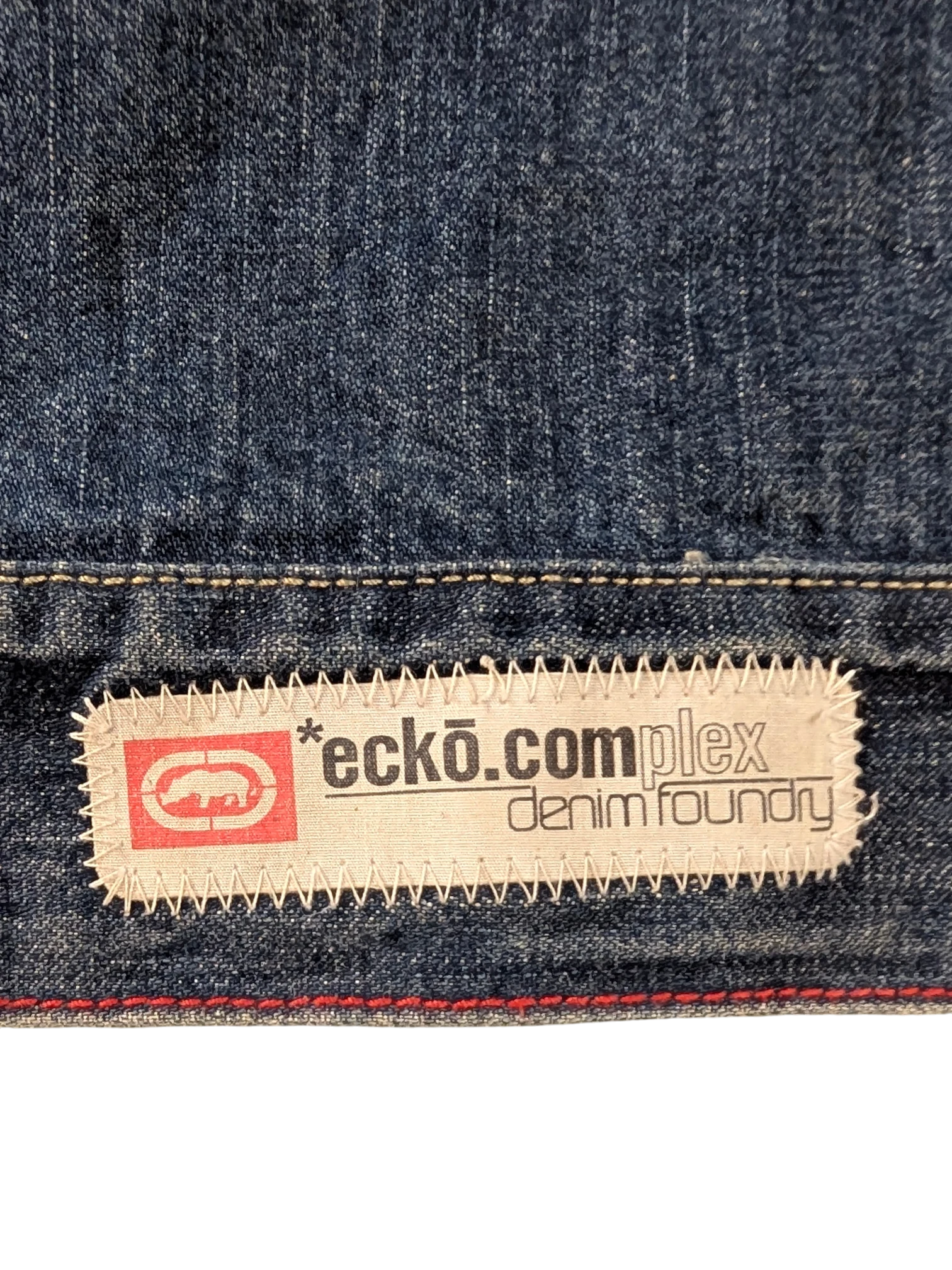 JAKE & IPI Ecko denim jacket with embroidered logo patch and red stitching detail.