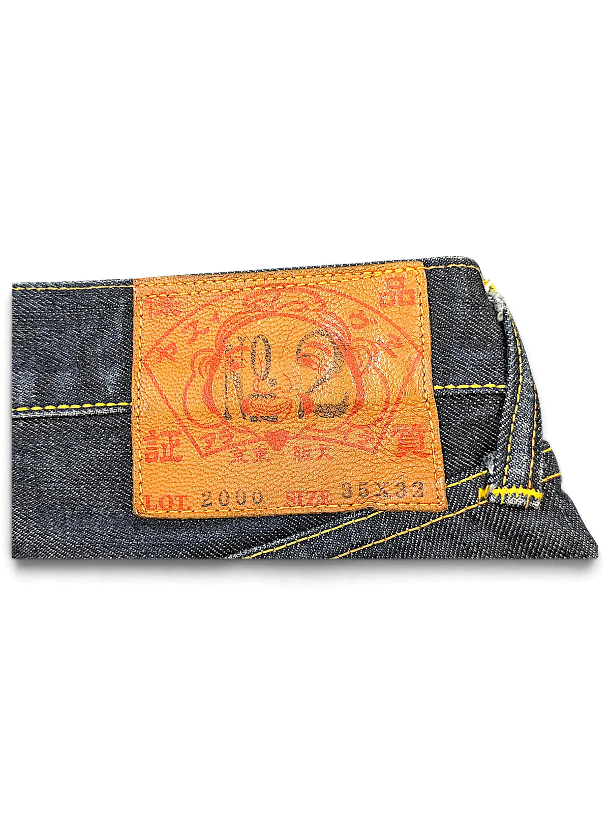 JAKE & IPI Evisu Lot 2000 jeans featuring a tan leather back patch with red graphic branding and yellow stitching.