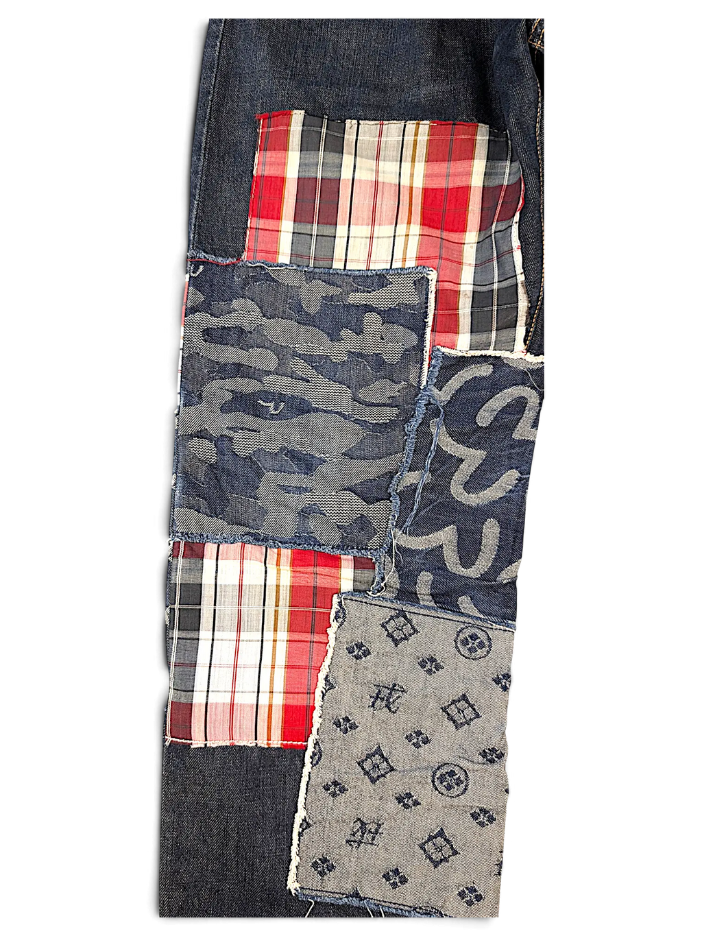 JAKE & IPI Evisu One Of One jeans featuring a dark denim patchwork design with plaid, camo, and monogram fabric.