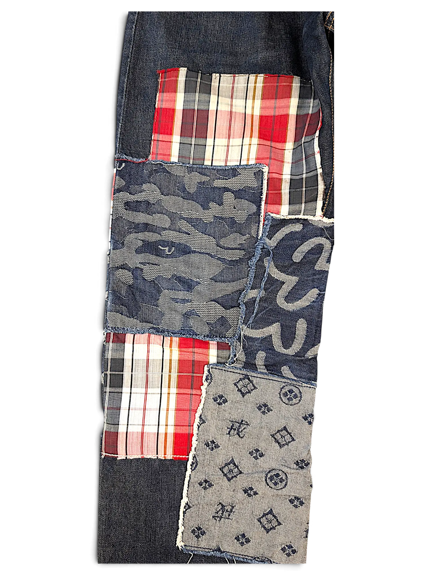 JAKE & IPI Evisu One Of One jeans featuring a dark denim patchwork design with plaid, camo, and monogram fabric.