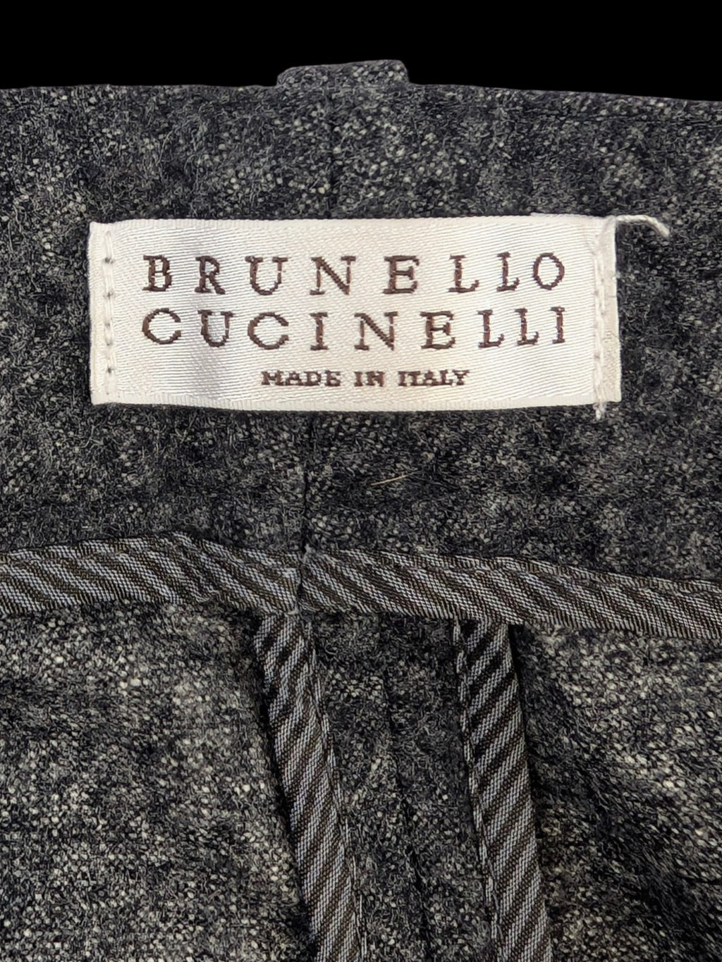 JAKE & IPI grey mélange wool blend flannel tailored trousers with subtle taper and horn-style buttons.