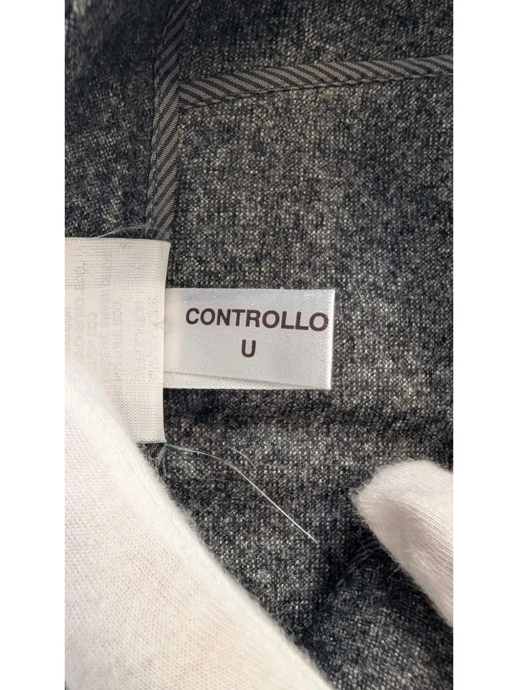 JAKE & IPI grey mélange wool blend tailored trousers with subtle taper and flannel finish.