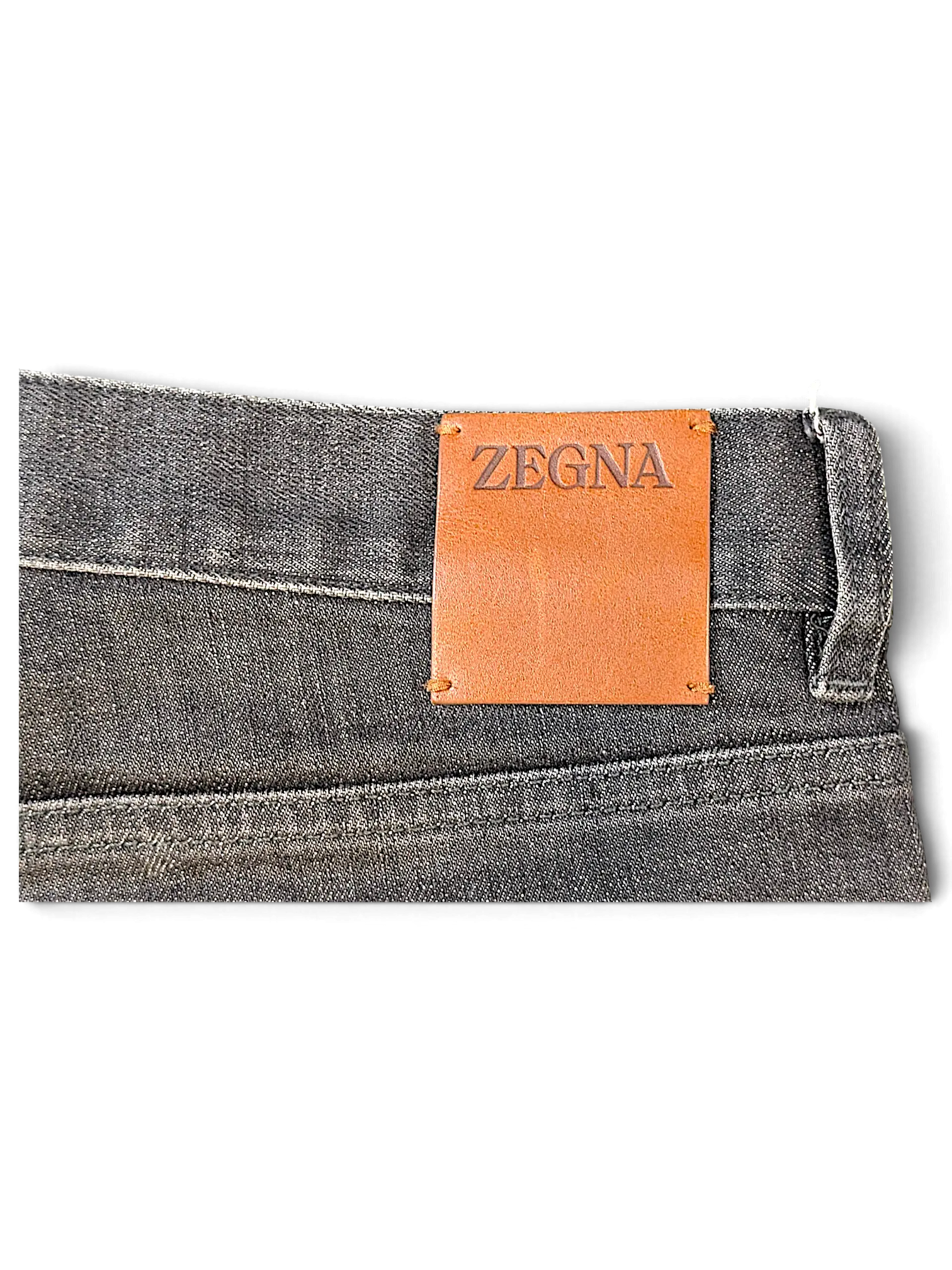 JAKE & IPI grey denim jeans featuring a tan leather Zegna brand patch on the back waistband