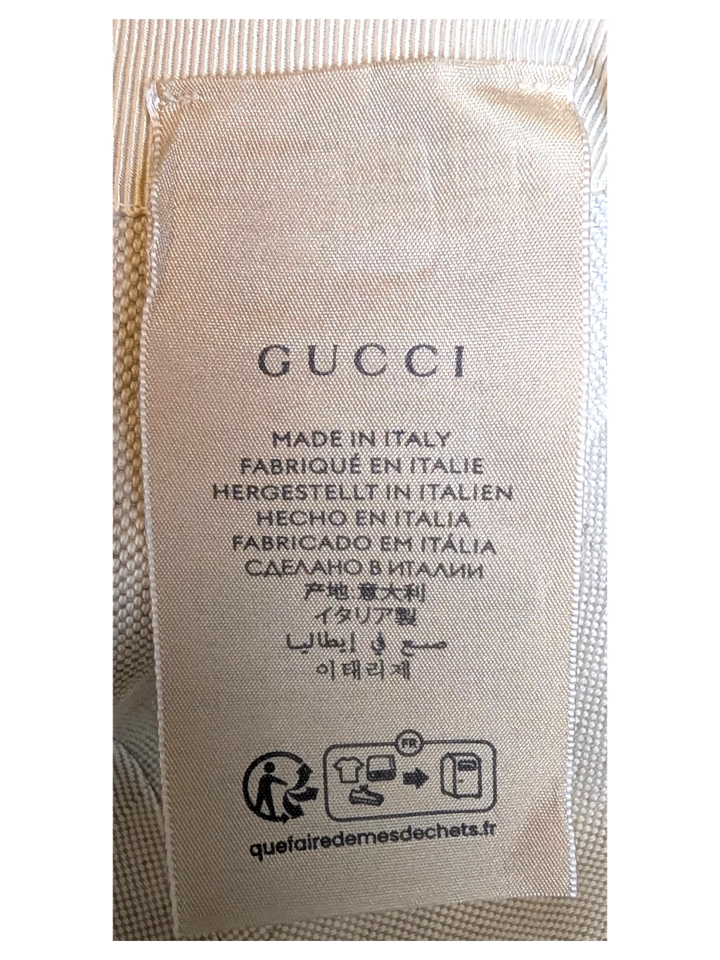 JAKE & IPI Gucci blue cap interior fabric care label with Made in Italy text and recycling symbols