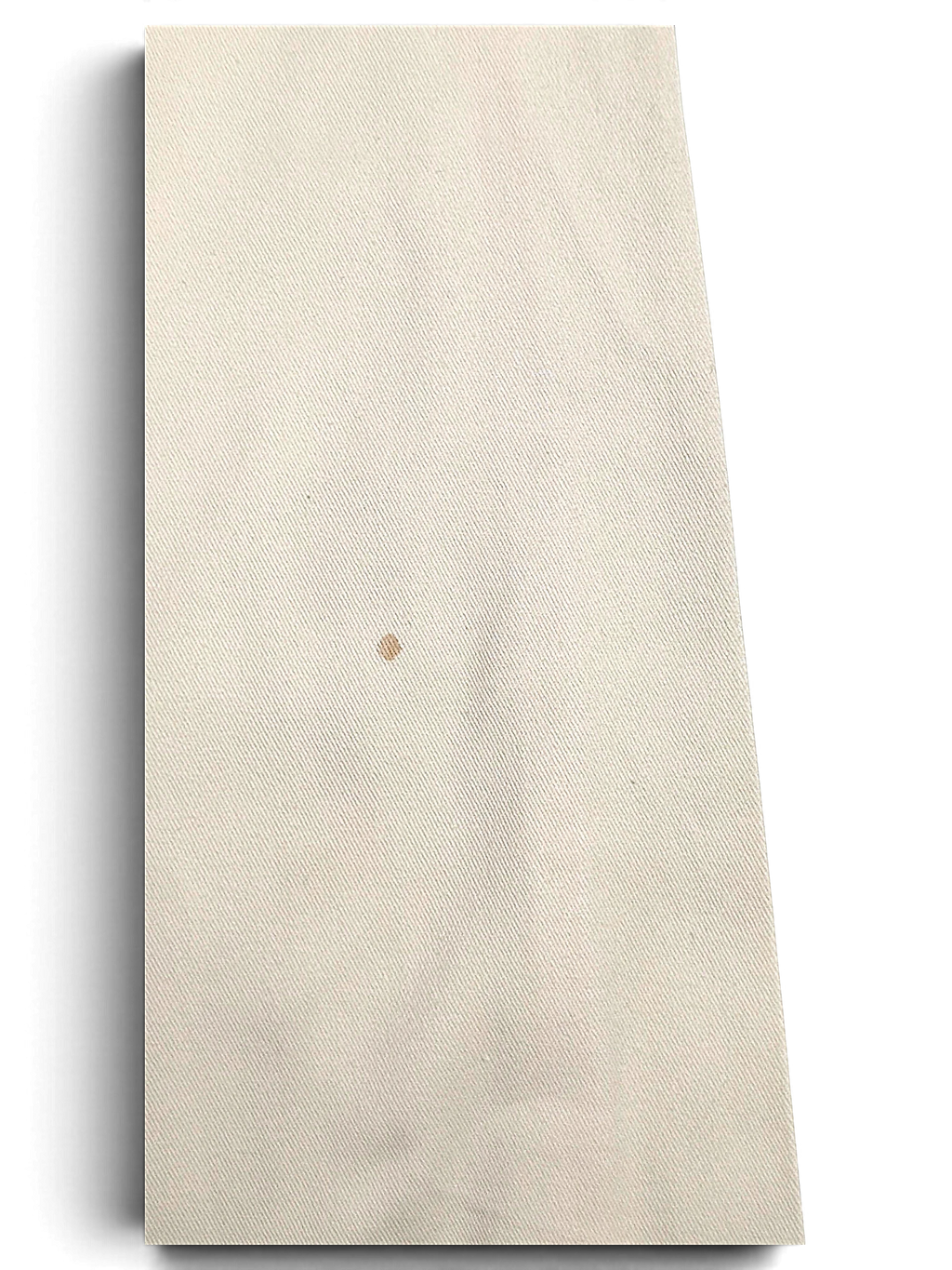 JAKE & IPI Indian Rose white cotton cargo pant fabric showing a small brown stain on the textured material