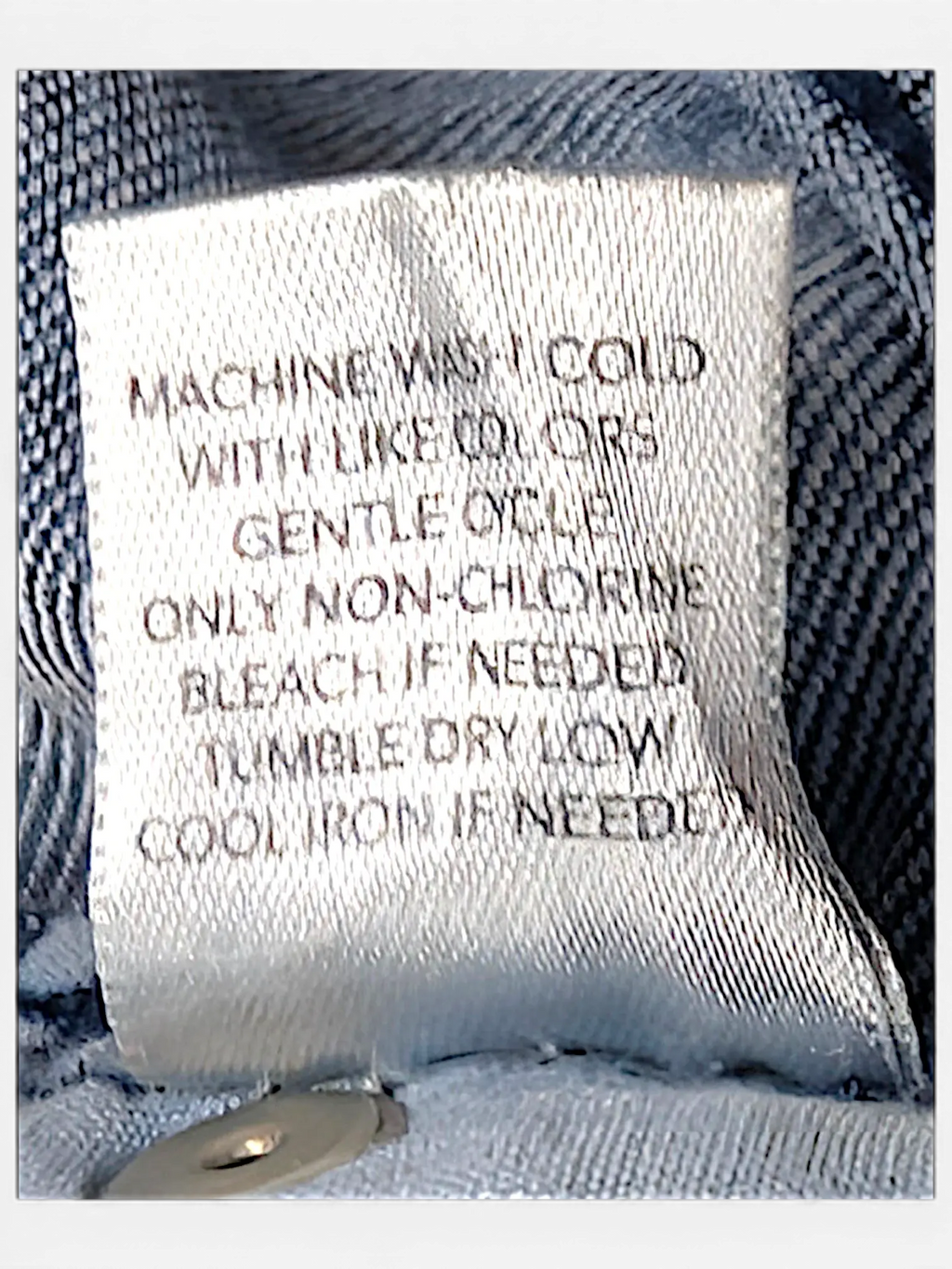 JAKE & IPI CJ Banks jeans care label with washing instructions stitched onto blue denim fabric
