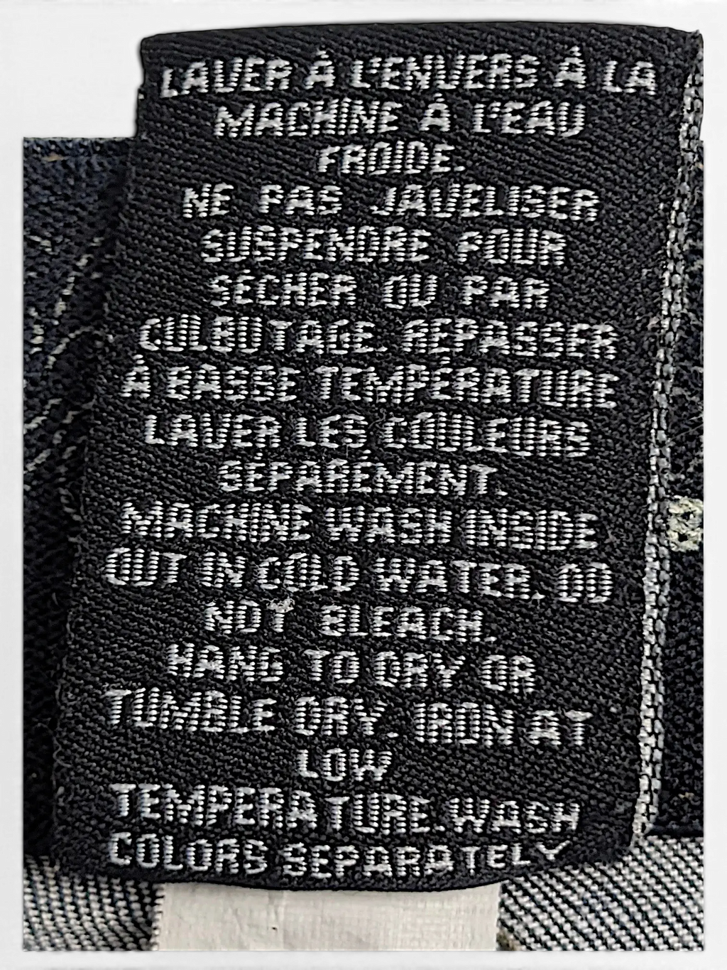 JAKE & IPI Lois Jane jeans care label with washing instructions in English and French on dark denim fabric