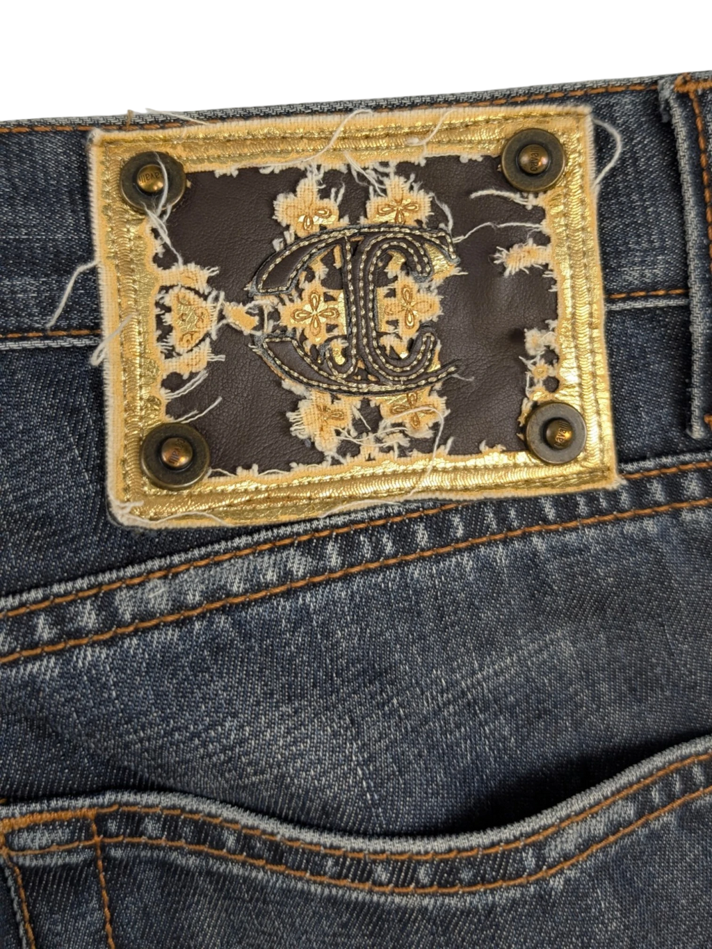 JAKE & IPI Just Cavalli distressed medium-wash blue denim jeans with contrast tobacco stitching and embroidered leather logo patch.