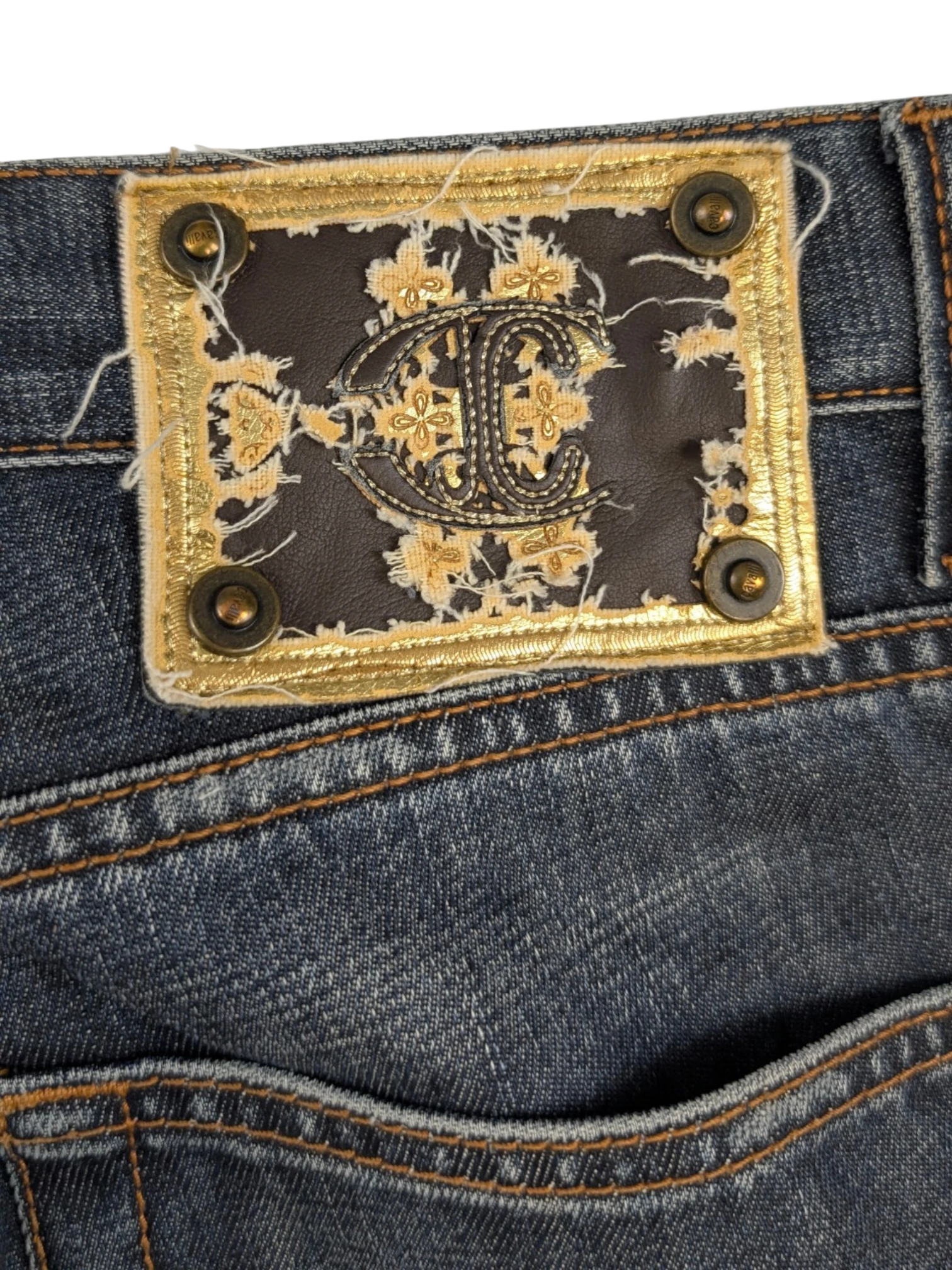 JAKE & IPI Just Cavalli distressed medium-wash blue denim jeans with contrast tobacco stitching and embroidered leather logo patch.
