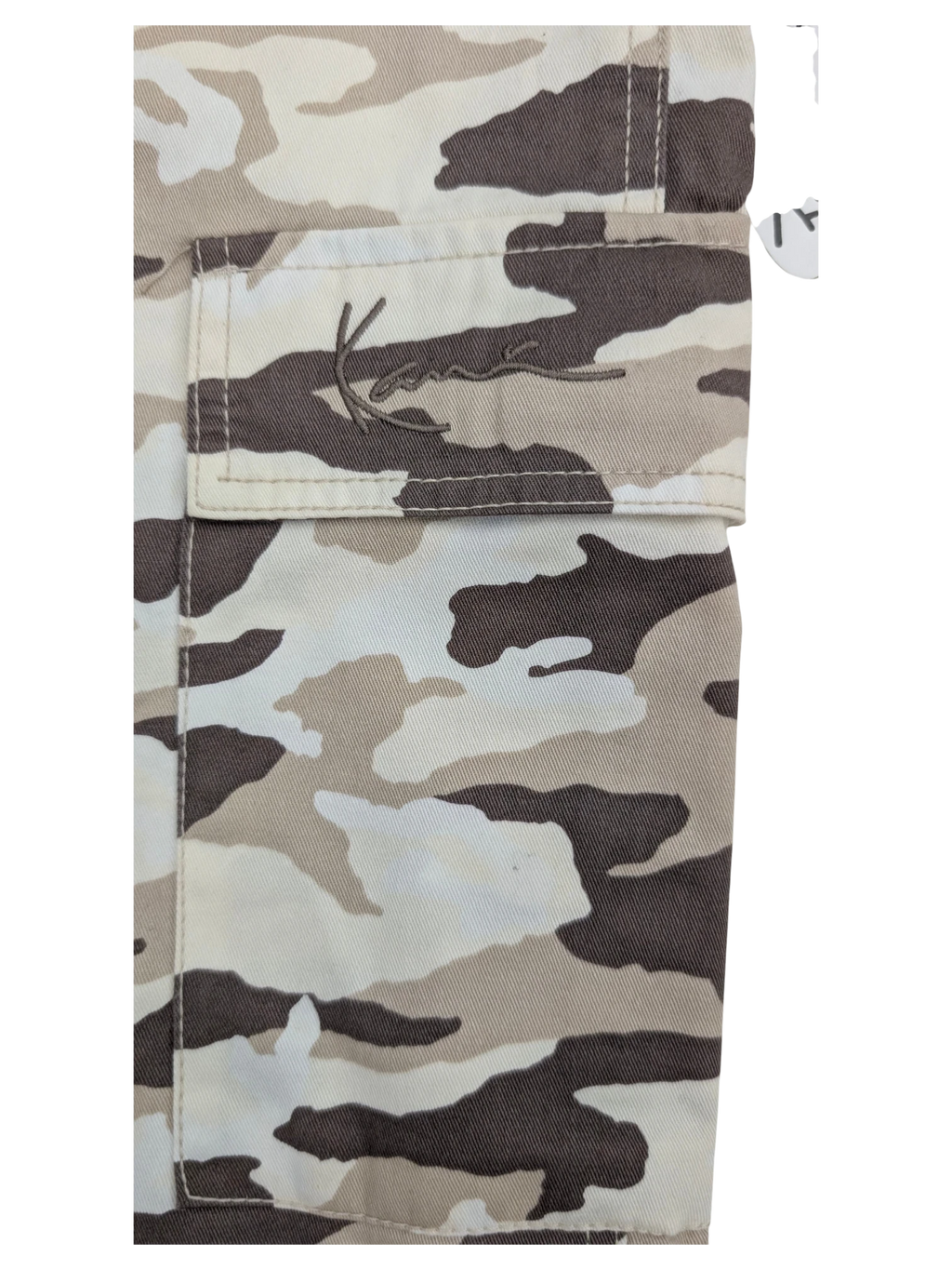 JAKE & IPI Karl Kani camouflage cargo pants in beige, white, and brown. Features embroidered logo on pocket.