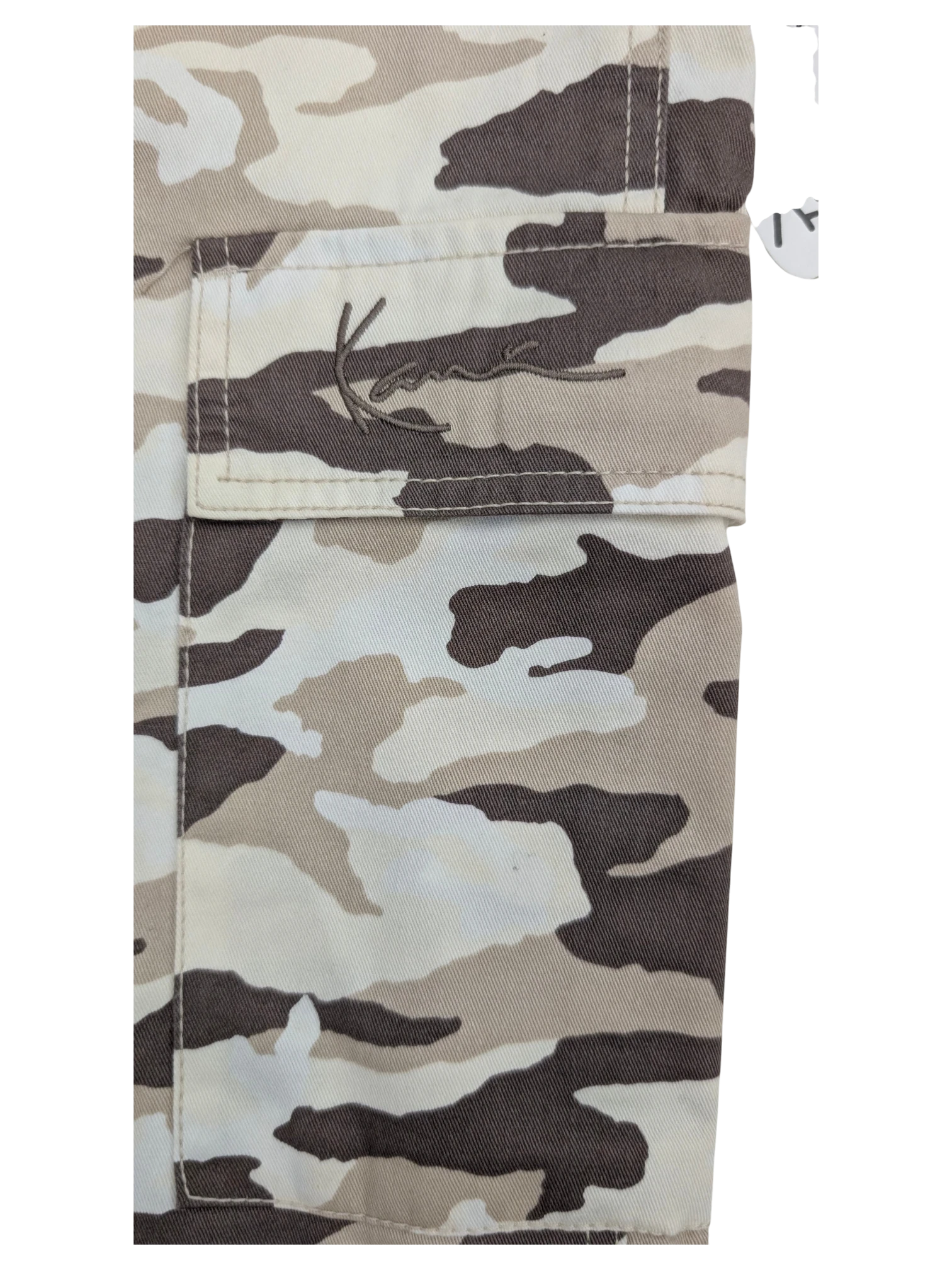 JAKE & IPI Karl Kani camouflage cargo pants in beige, white, and brown. Features embroidered logo on pocket.