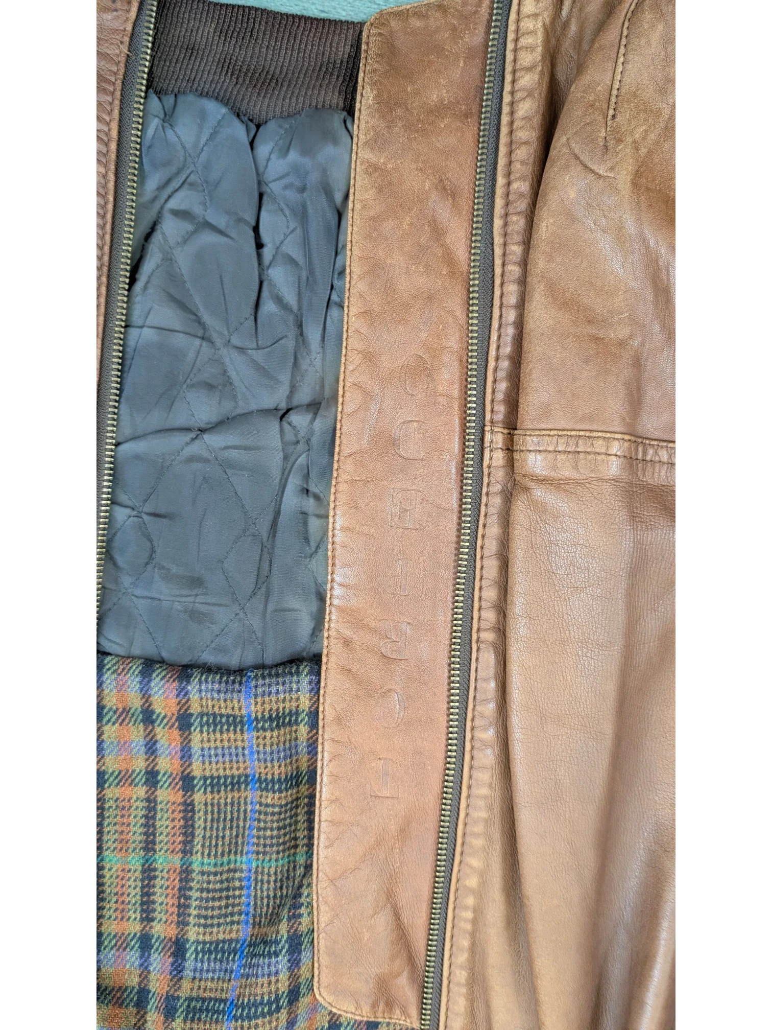 JAKE & IPI Josef Wormland brown leather jacket with quilted lining and plaid interior.