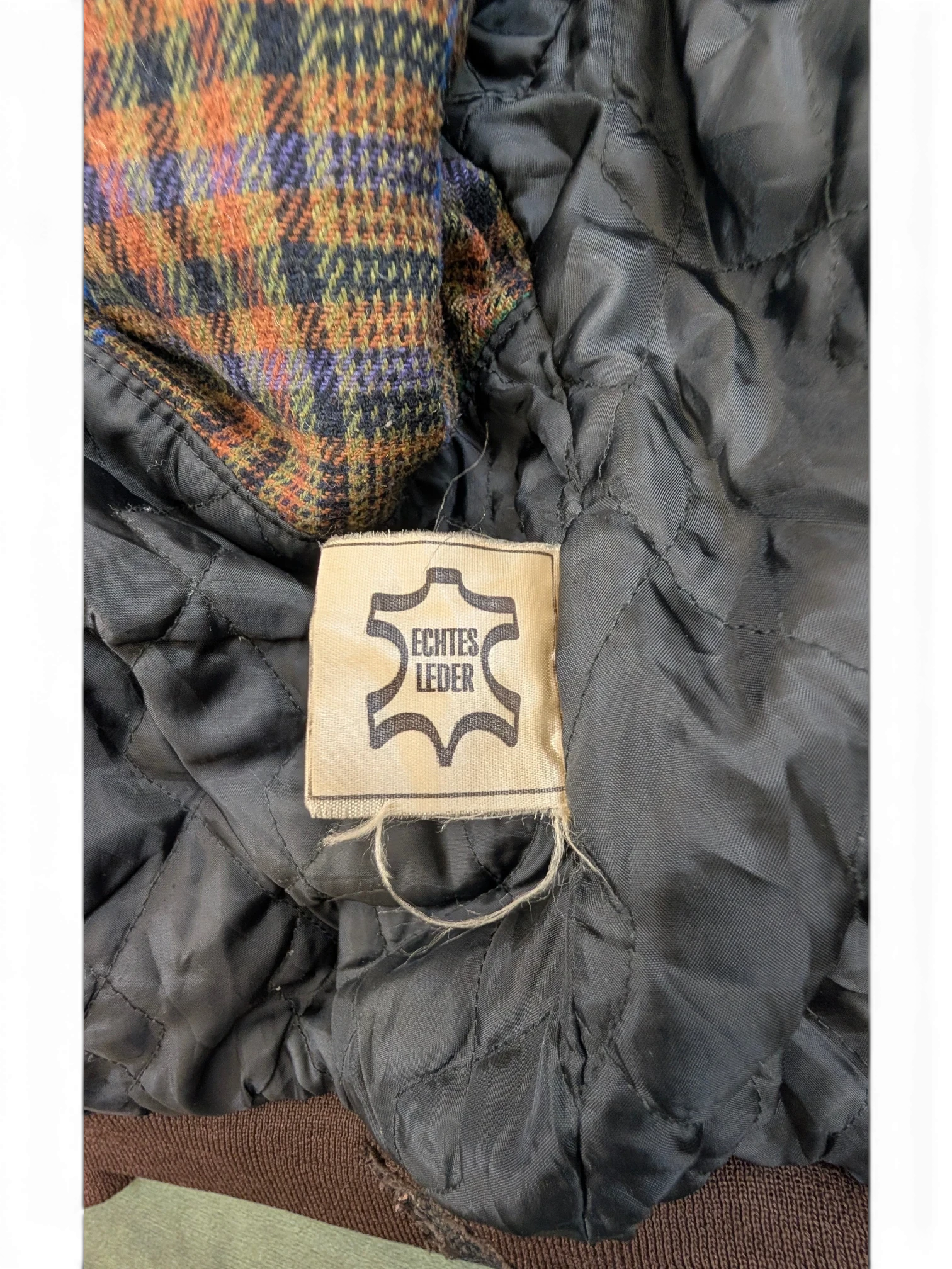 JAKE & IPI Josef Wormland leather jacket lining with plaid fabric detail and "Echtes Leder" tag.