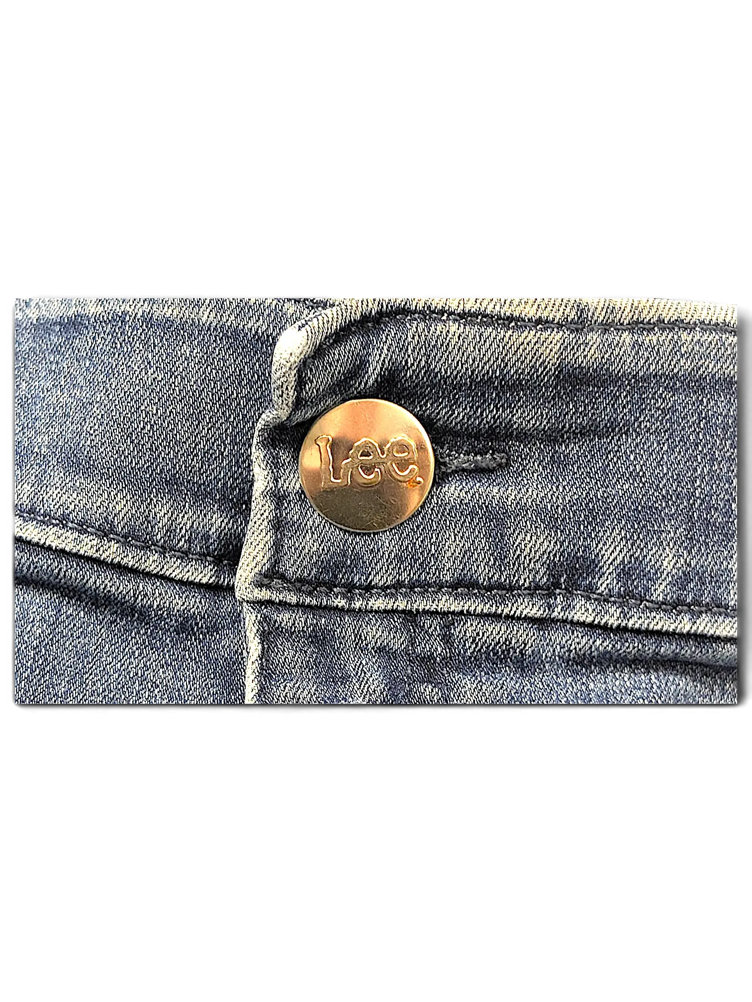 Close-up of a brass-toned metal button with Lee branding on blue denim jeans from JAKE & IPI