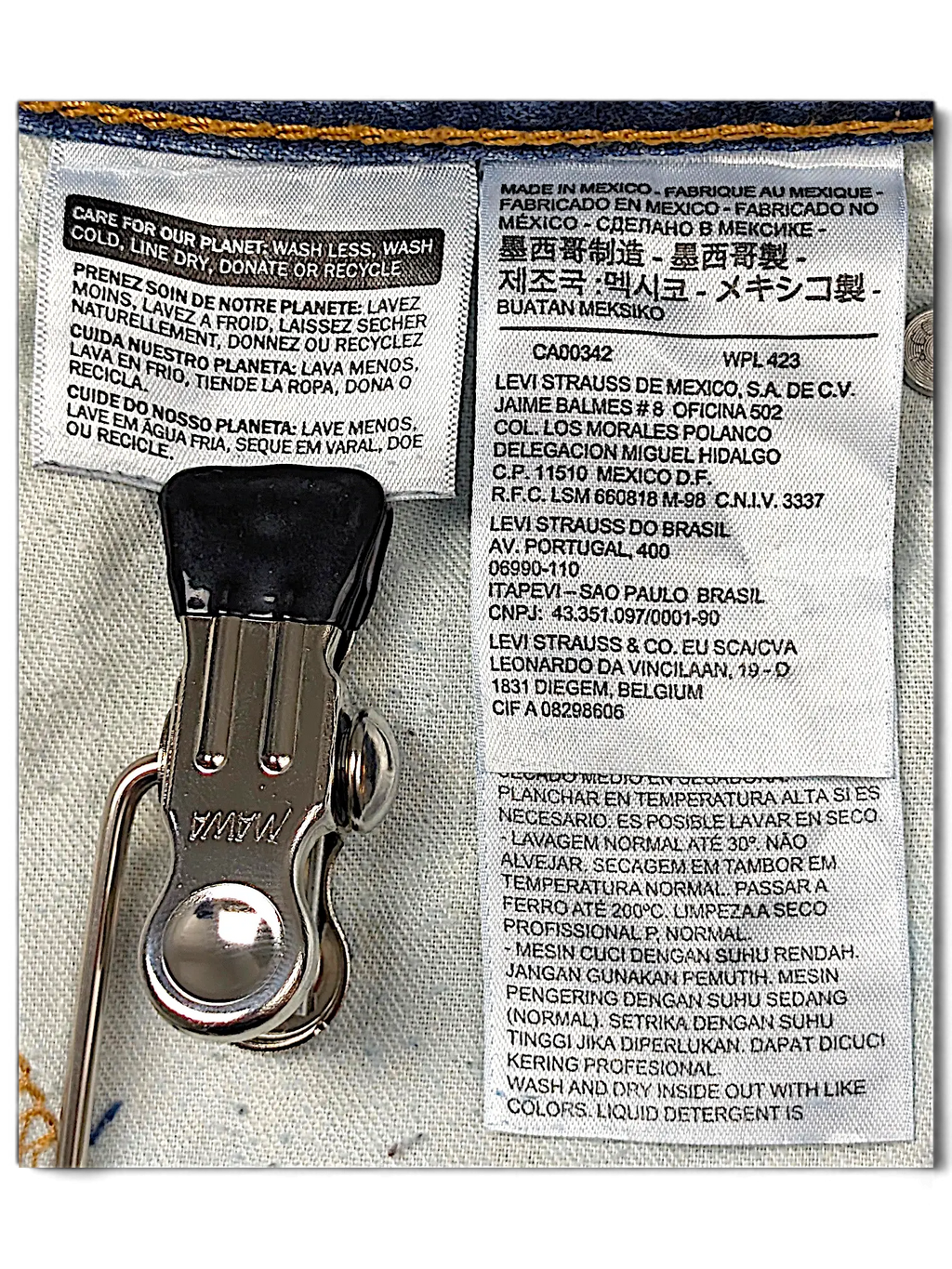 JAKE & IPI Levi's 511 jeans white fabric care and origin label with metal clothing hanger clip