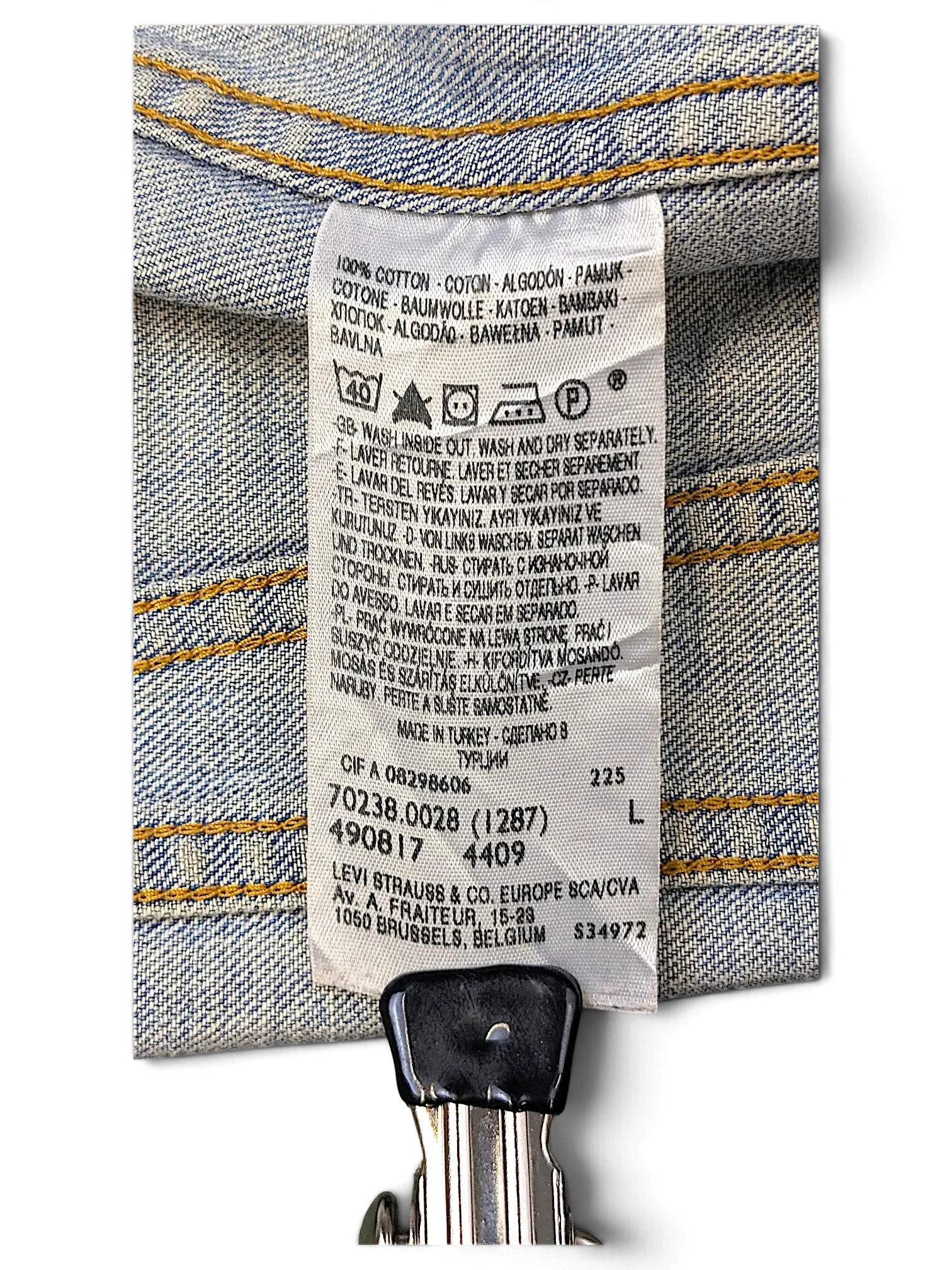 JAKE & IPI Levi's distressed denim jacket care label showing 100% cotton material and washing instructions