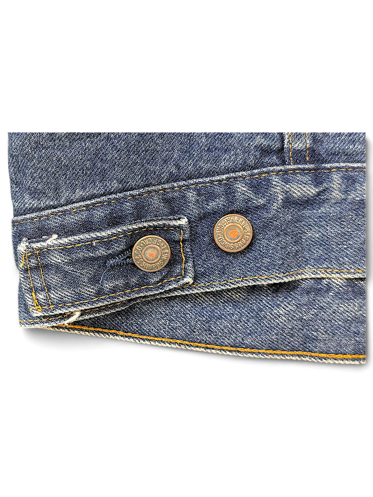 JAKE & IPI Levi's denim jacket hem detail showing copper buttons and orange stitching on blue fabric