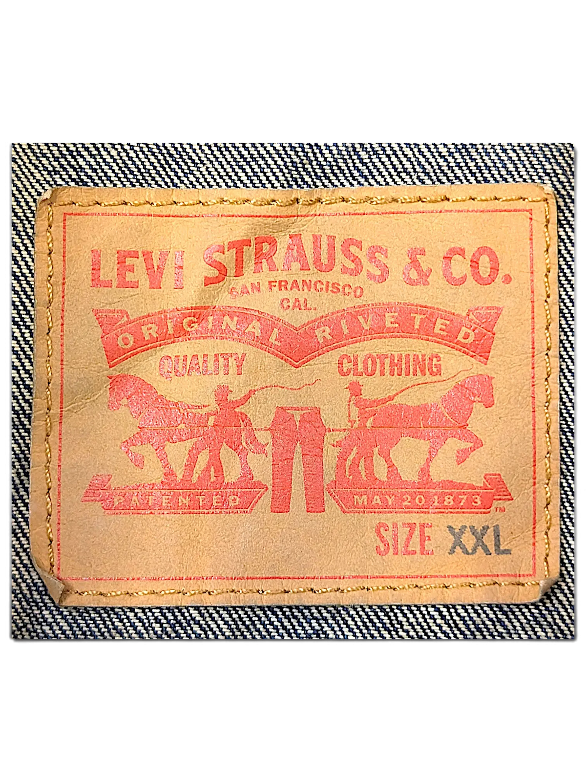 JAKE & IPI Levi's denim vest tan leather brand patch with red logo and size XXL label stitched on blue denim fabric