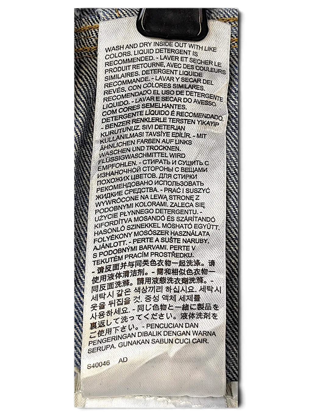 JAKE & IPI Levi's Strauss girls jacket care label with multi-language washing instructions on white fabric