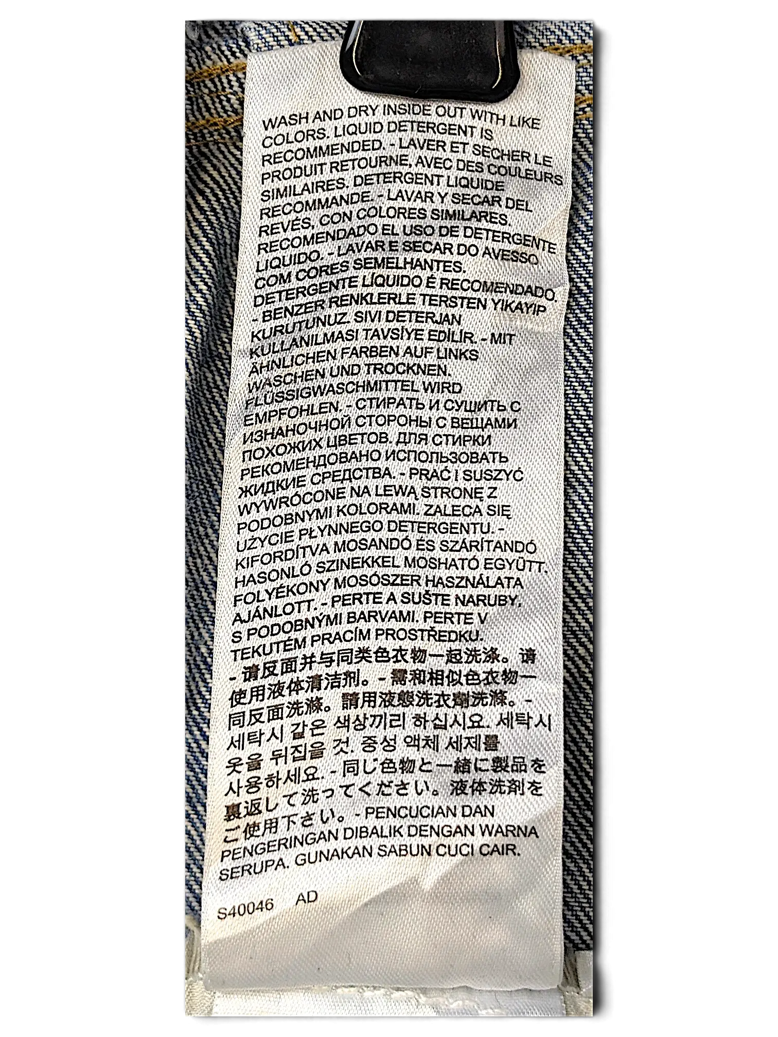 JAKE & IPI Levi's Strauss girls jacket care label with multi-language washing instructions on white fabric