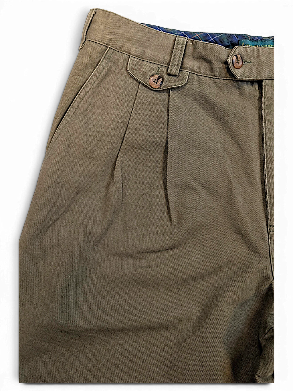 JAKE & IPI Liberty vintage olive green pleated trousers with a buttoned front pocket and plaid waistband lining.