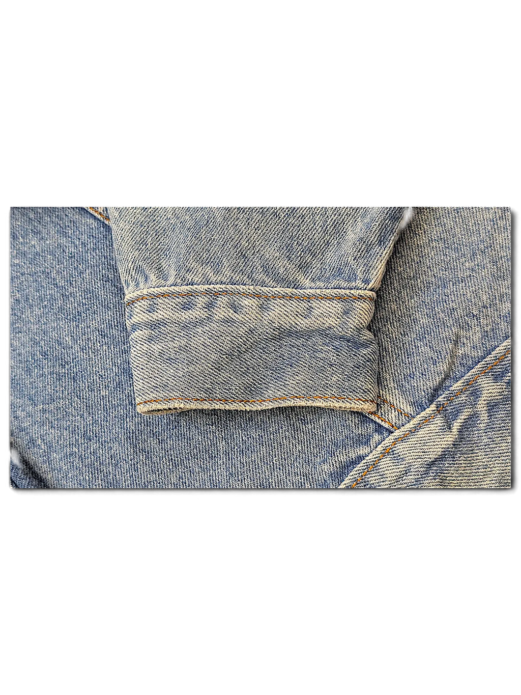 Close-up of a JAKE & IPI light wash denim jacket sleeve cuff with visible stitching and worn texture