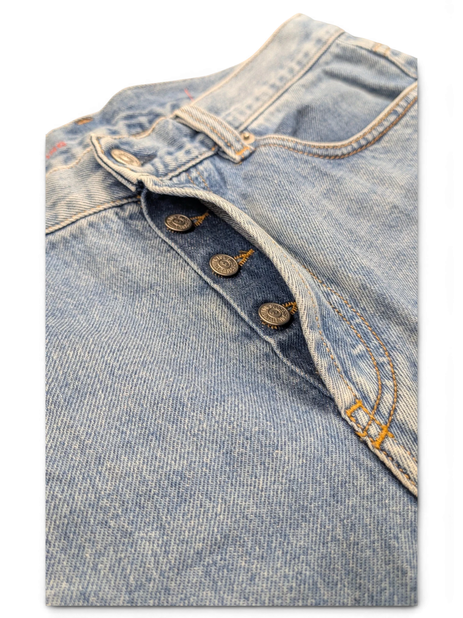 JAKE & IPI light wash denim jeans with button fly and copper-toned buttons. Classic 5-pocket style.