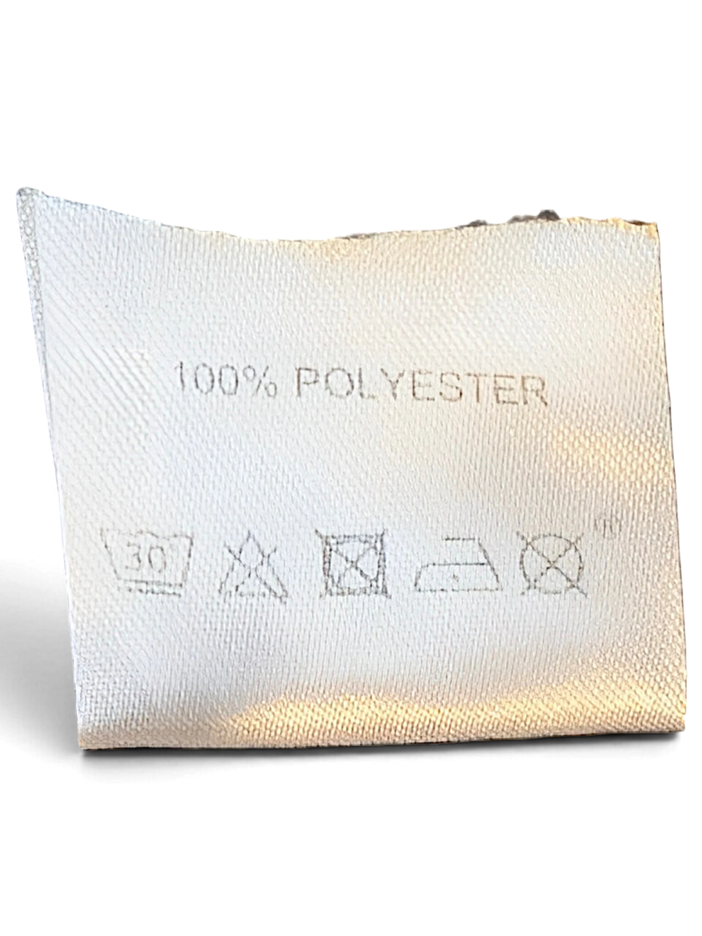 JAKE & IPI Lotto track pants care label showing 100% polyester composition and laundry instructions