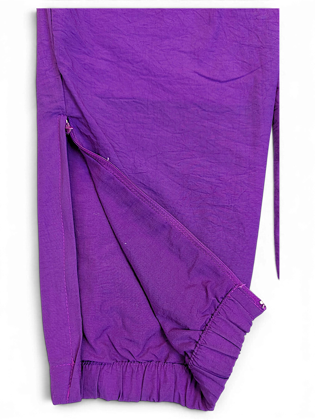 JAKE & IPI pre-owned Lotto purple track pants featuring a side zipper detail and elasticated cuffs