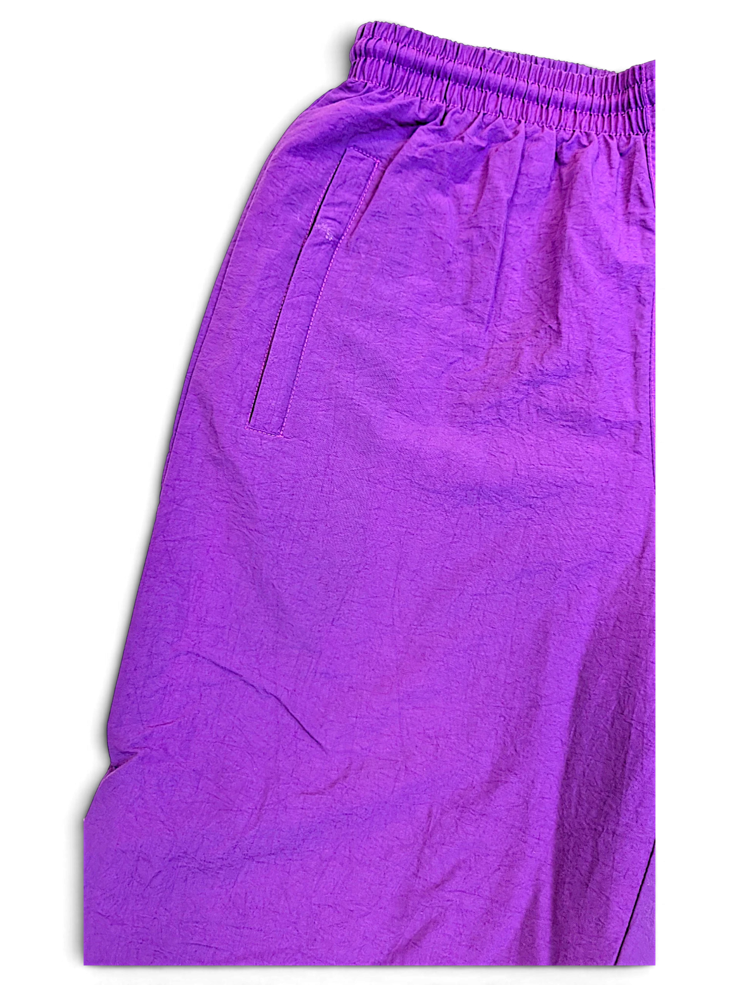 JAKE & IPI pre-owned Lotto purple track pants with an elasticated waistband and side pocket detail.