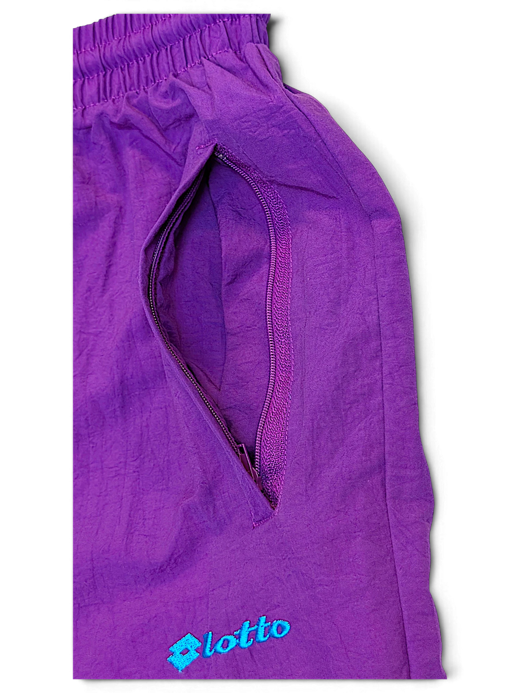 JAKE & IPI pre-owned purple Lotto track pants featuring a zippered side pocket and embroidered logo detail.