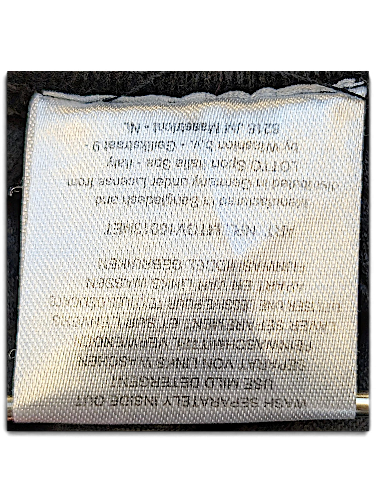 JAKE & IPI Lotto track pants care label with washing instructions and manufacturing details