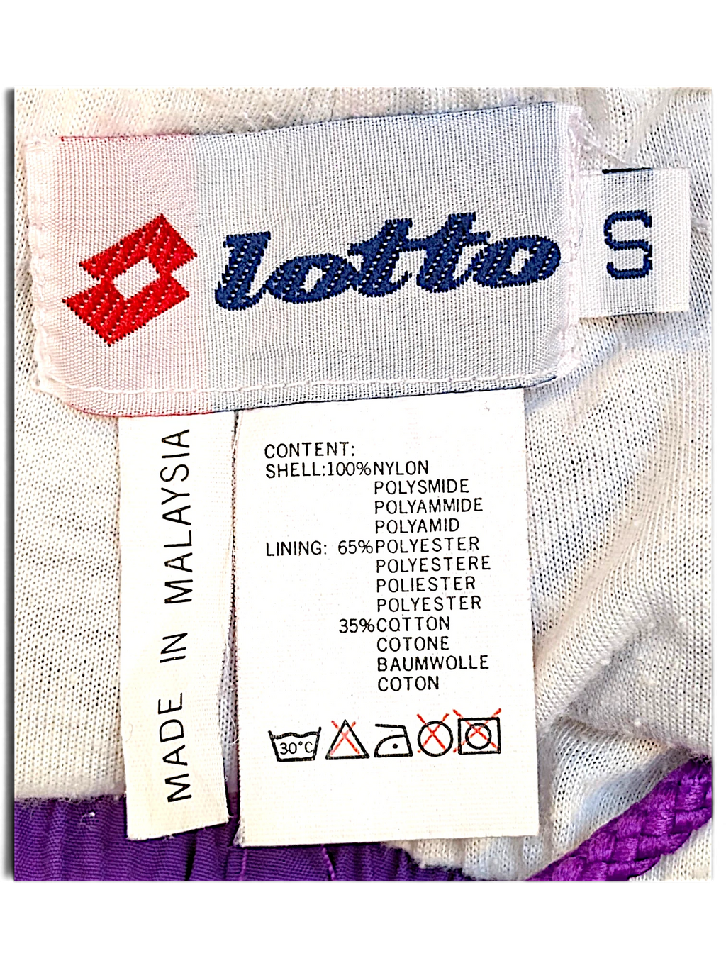 JAKE & IPI Lotto track pants size S label showing 100% nylon shell and polyester cotton lining details