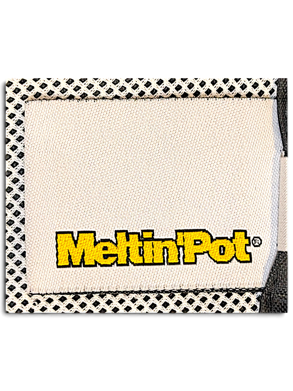 JAKE & IPI Meltin'Pot brand clothing label stitched onto a white mesh interior lining of windbreaker pants.