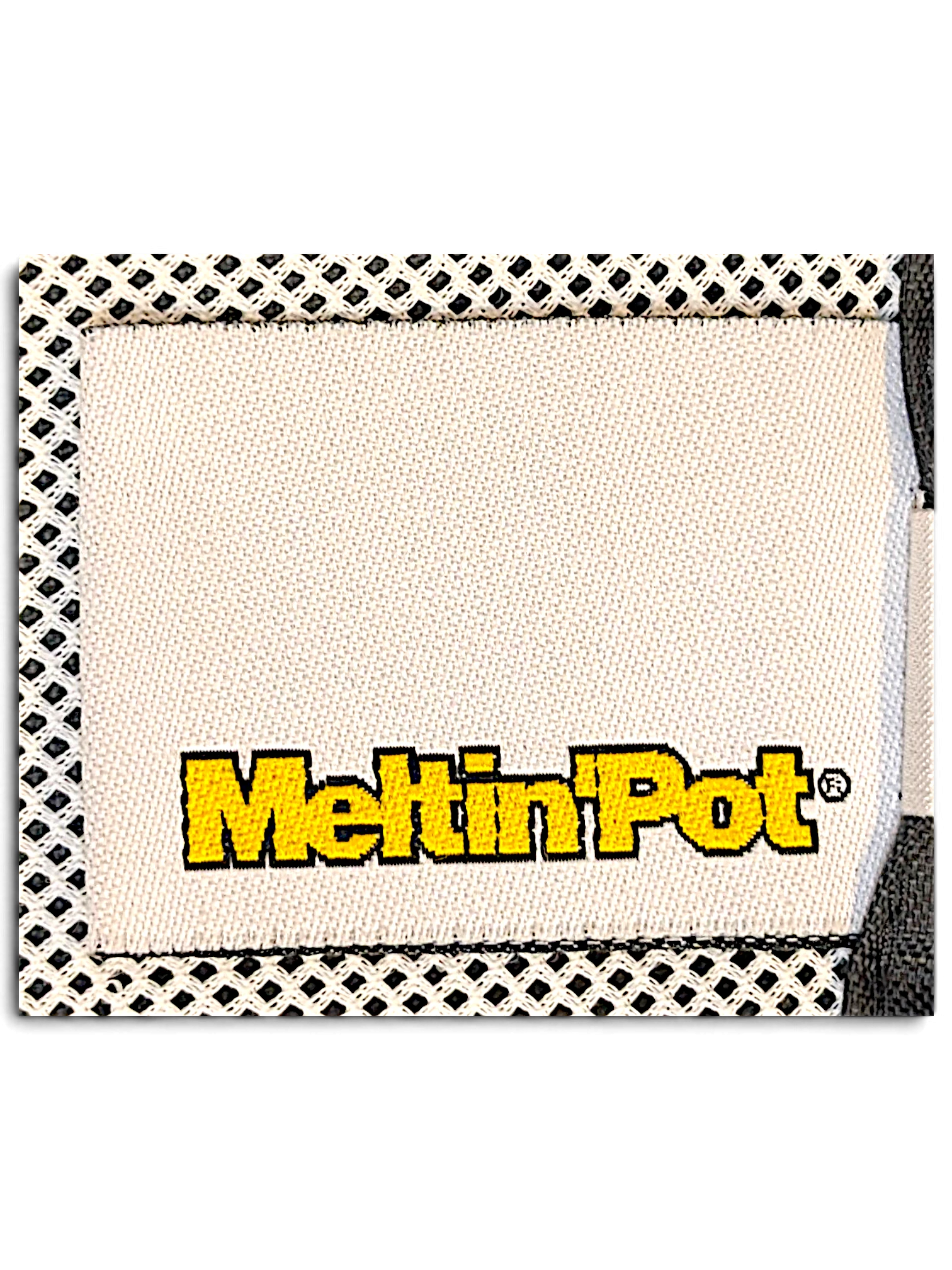 JAKE & IPI Meltin'Pot brand clothing label stitched onto a white mesh interior lining of windbreaker pants.